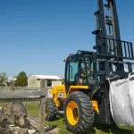 JCB 950 rough terrain forklift transporting materials on pig farm.