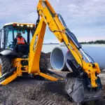 JCB 4CX Backhoe Loader digging on construction site.