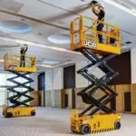JCB S2632E electric scissor lift lifting operators to repair ceiling.