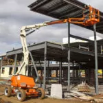 JLG 340AJ Articulating Boom Lift being used on a construction site.