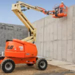 JLG 450AJ Articulating Boom Lift being used at a job site.