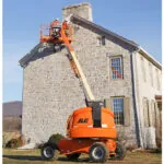 JLG 460SJ boom lift raised at outdoor jobsite.