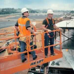 JLG 800S boom lift raised at worksite.