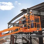 JLG 860SJ boom lift with bucket raised at jobsite.