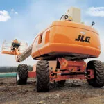 JLG 860SJ telescopic boom lift on dirt terrain.
