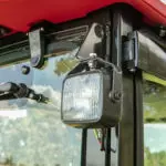 close up of light attached to Mahindra 1640 compact utility tractor cab.
