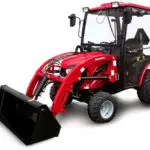Mahindra eMax 25L HST sub-compact tractor with cab and bucket attachment.