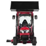 Front of Mahindra eMax 25L HST sub-compact tractor with cab and raised bucket attachment.