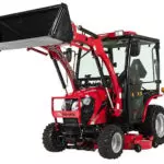 Mahindra eMax 25L HST sub-compact tractor with cab and raised bucket attachment.