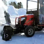 Mahindra eMax 25L tractor snow-blowing.