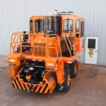 Rail King RK330 G6 railcar mover parked right outside a facility building.