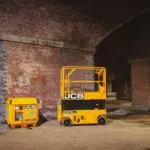 JCB 1930E scissor lift in a brick building.