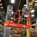Skyjack SJ16 E vertical mast lift and operator.