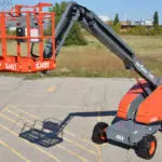 Skyjack SJ40/45 T+ telescopic boom lift parked in parking lot in front of field.