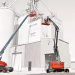 Skyjack SJ63 T and SJ66 T+ aerial booms lifting operators up to a building.