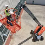 Operator wearing PPE being lifted by a Skyjack SJ61/66 T+ telescopic boom.