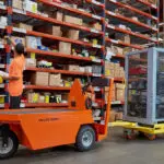 Taylor-Dunn SC-90 Stock Chaser utility vehicle hauling CarryMore industrial cart.