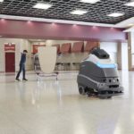 Advance Liberty SC50 autonomous floor scrubber cleaning cafeteria floors.