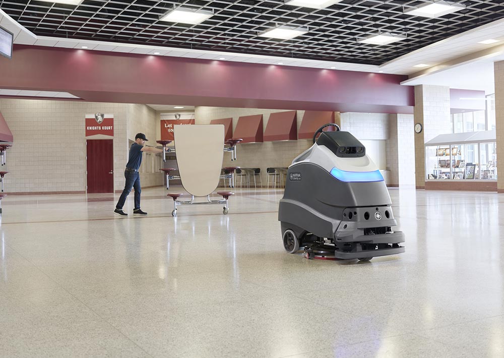 Advance Liberty SC50 autonomous floor scrubber cleaning cafeteria floors.