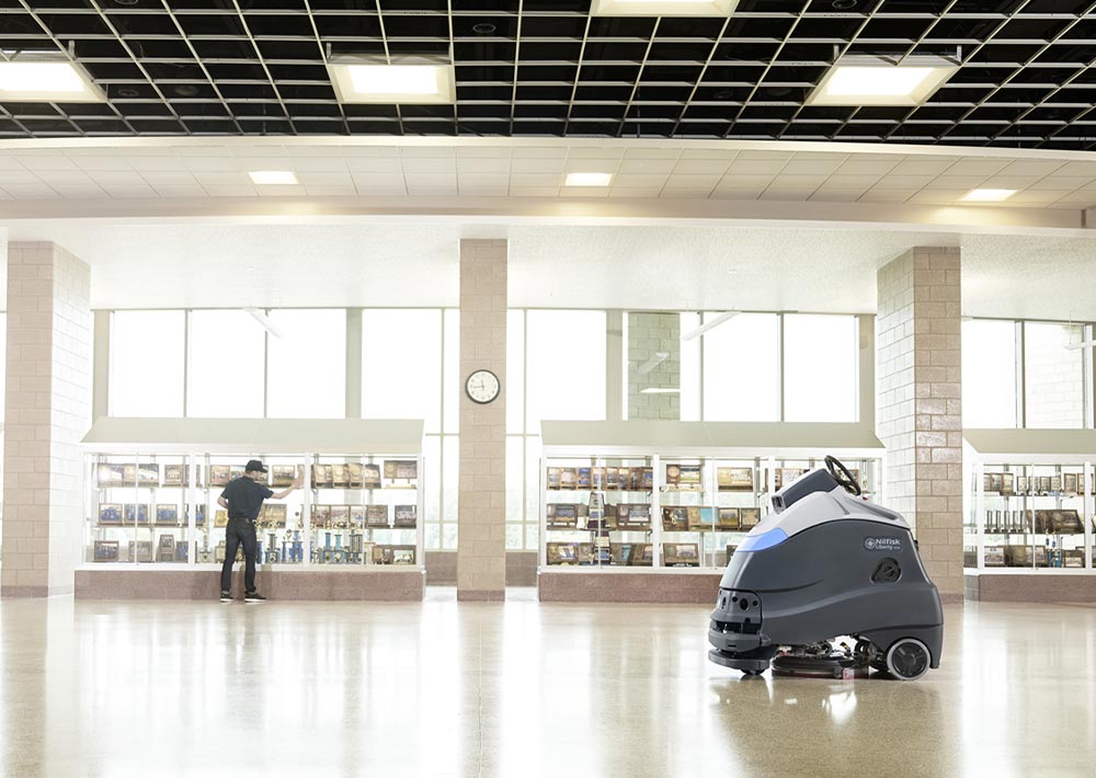 Advance Liberty SC50 professional autonomous scrubber cleaning large empty room.