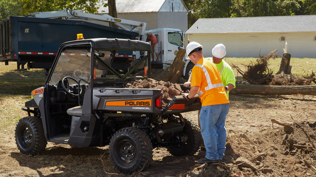 dirt being loaded into the bed of Polaris Commercial Pro XD Full-Size Gas utility vehicle