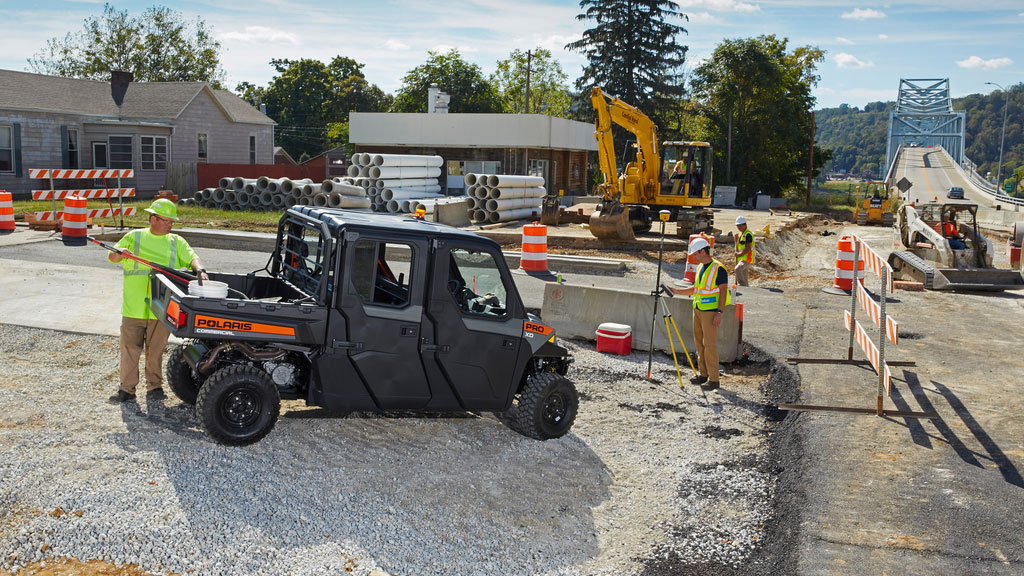 Polaris Commercial PRO XD Full-Size Diesel Crew UTV side view with doors on gravel work site.