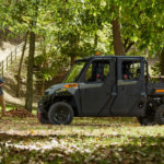 Pro XD Full-Size Gas Crew Utility Vehicle by Polaris Commercial with doors on dirt trail.