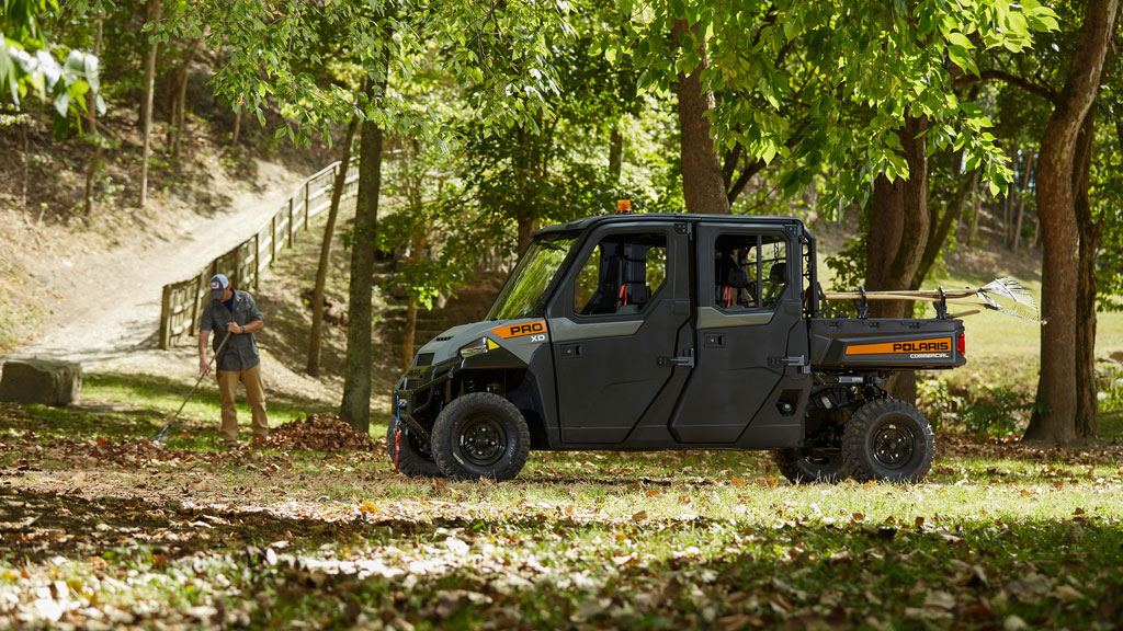 Pro XD Full-Size Gas Crew Utility Vehicle by Polaris Commercial with doors on dirt trail.