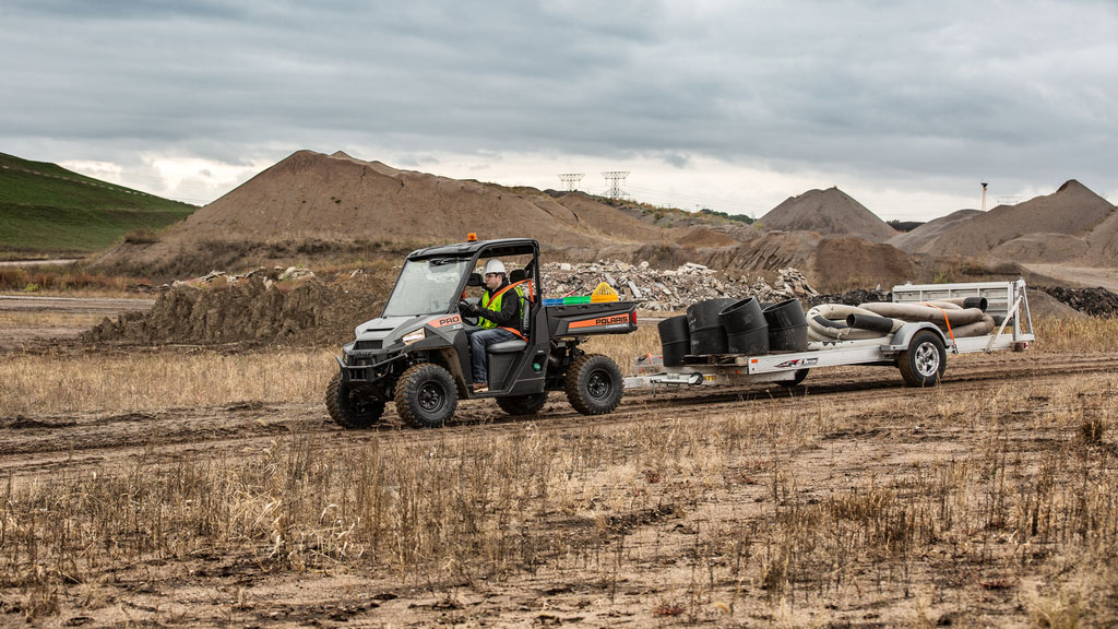Polaris Commercial PRO XD Full-Size Diesel Utility Vehicle on dirt road.