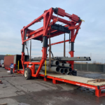 Combilift Combi-CSS container slip sheet, pipes, and toplift straddle carrier.