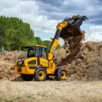 JCB TM-220 articulated telescopic handler dumping dirt.