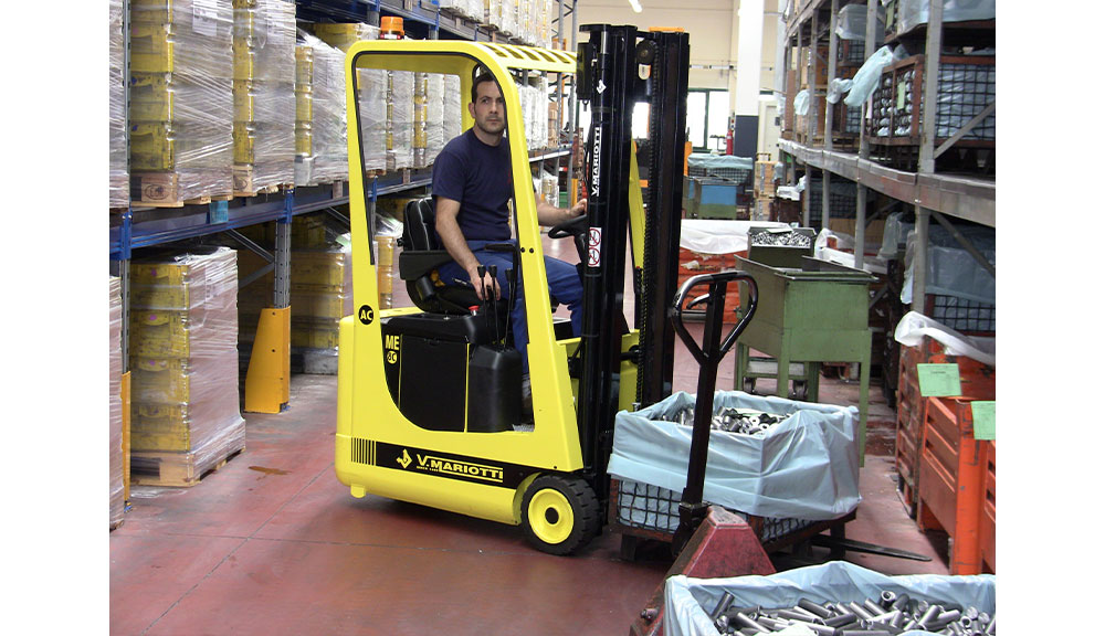 Mariotti ME 8C AC 3 wheel electric Forklift transporting metal parts.