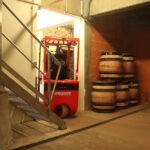 Mariotti Mycros AC forklift driving through a doorway in a winery.