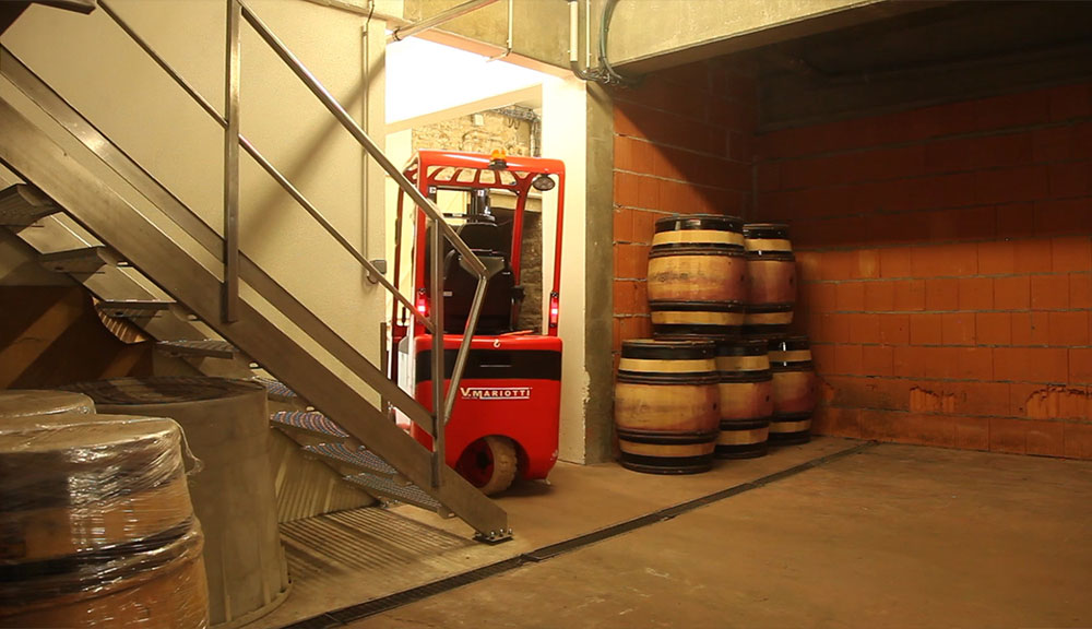 Mariotti Mycros AC forklift driving through a doorway in a winery.