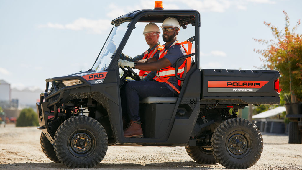 Pro XD Mid-Size Gas Utility Vehicle by Polaris Commercial in action on outdoor work site.