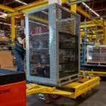 Taylor-Dunn Jtec CarryMore industrial cart burden carrier in warehouse.
