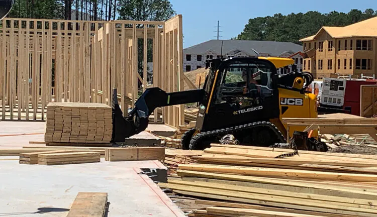 JCB 3TS-8T Teleskid transporting pallet of lumber.