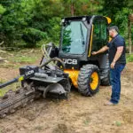 Operator opening JCB 215 Skid Steer door.