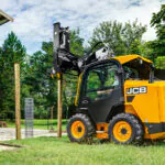 JCB 215 Skid Steer loader performing yardwork.