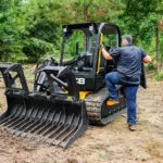 Operator getting into a JCB 270T compact track loader.