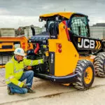 operator checking the engine area of a JCB 3TS-8W teleskid.