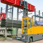 Combilift COMBI-MR4 electric forklift stacking materials outdoors.