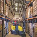Combilift Aisle Master LPG Forklift with mast up in warehouse.