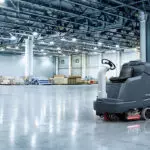 Advance SC5000 rider scrubber in an indoor warehouse manufacturing facility.