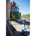 Construction workers in Genie S-60 DC Telescopic Boom Lift bucket.