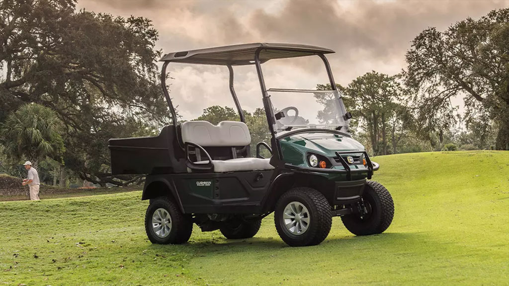 Cushman Hauler 800X Utility Vehicle near hill on golf course.