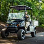 Cushman Hauler Pro-X utility vehicle driving down road.
