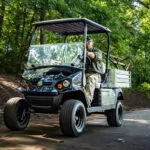 Cushman Hauler Pro-X utility vehicle driving down road.