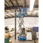 Genie GS-1932m scissor lift raising operators to ceiling.