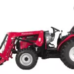 Side of Mahindra 2645 Shuttle tractor with bucket attachment.